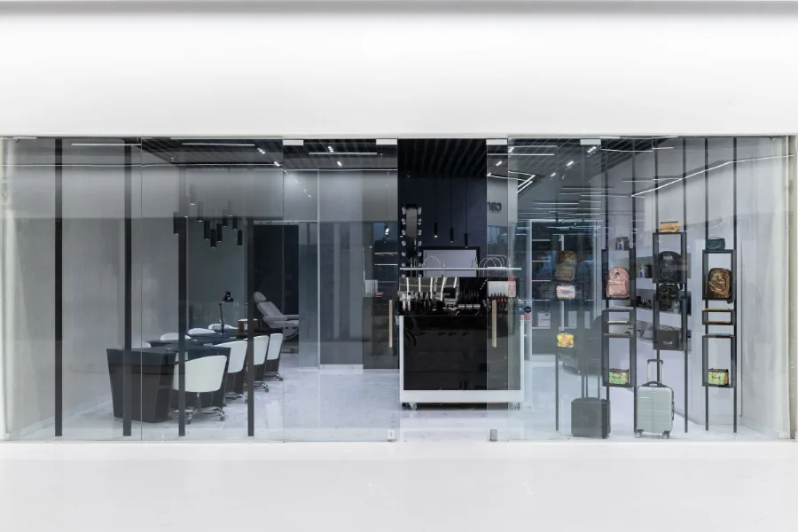 Full-height glazed retail frontage with glass entrance doors at ground level