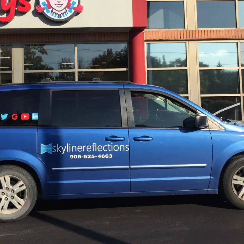 Skyline Reflections service vehicle parked at a commercial property during an architectural film installation