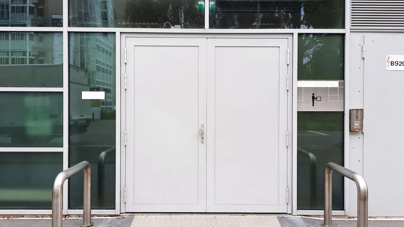 Glazed commercial entrance doors with side glazing at street level