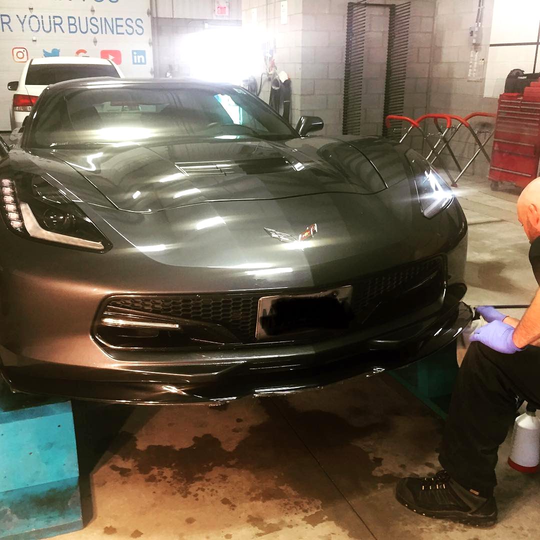 Dark grey performance car being worked on inside the Skyline Reflections shop