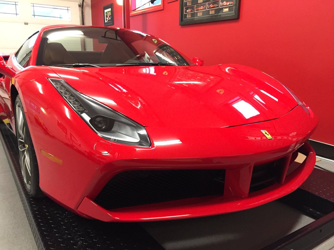 Red Ferrari sports car in the Skyline Reflections shop after automotive film work