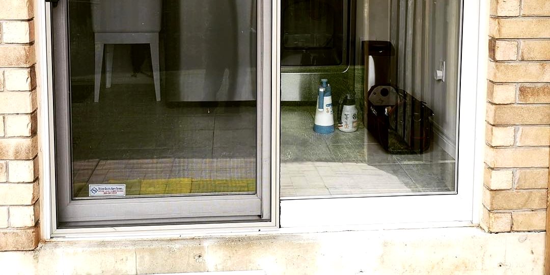 Sliding glass door treated with window film, seen from inside the property