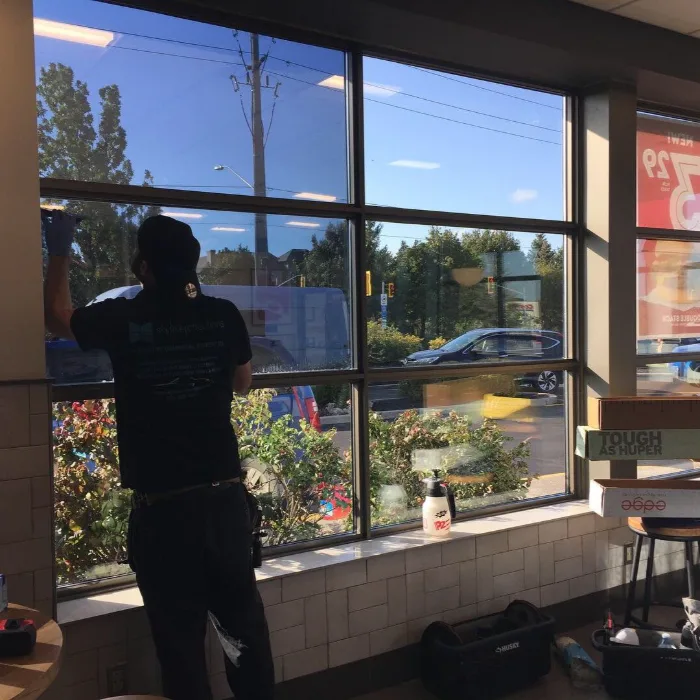 Full-height architectural glazing being filmed in a commercial unit